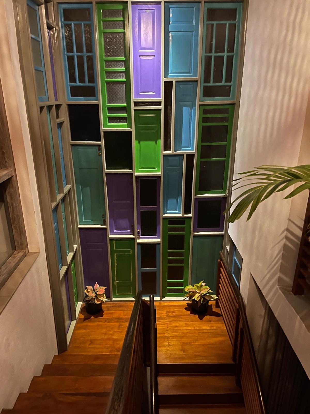 Upper floor sitting area with colored panel feature wall
